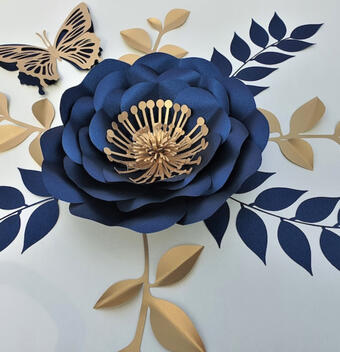 Elegant navy and gold paper flower decoration, featuring a stunning array of blooms with detailed petal cut-outs, perfect for weddings, anniversaries, and upscale room decor.